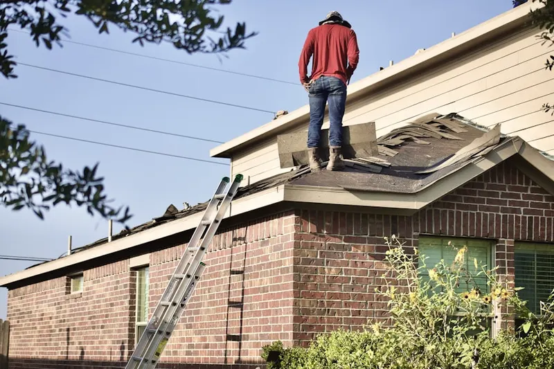 Professional roofer working on a residential roof in Coral Gables Section